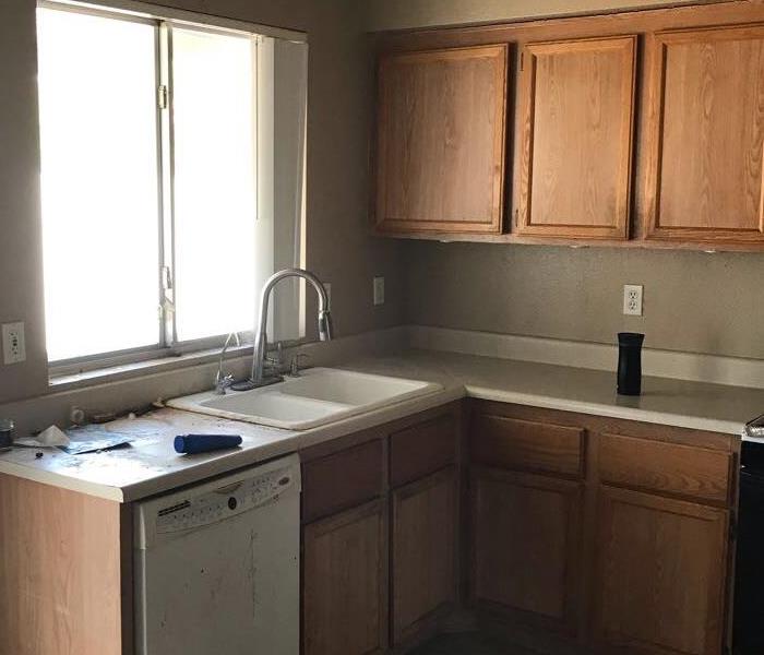 Kitchen with brown cabinets and hidden water damage. 