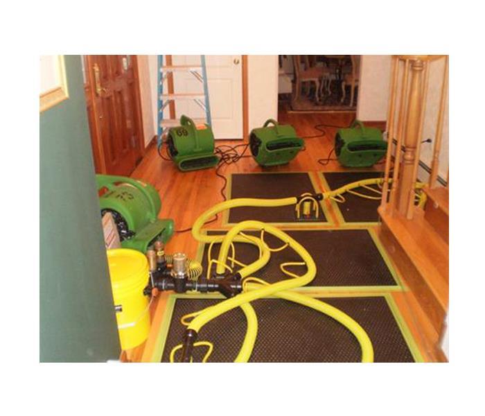 Four green air movers on the floor.